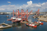 photo of the Port of Manzanillo with blue skies and fluffy white clouds
